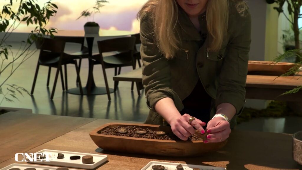 Geperste koffiepucks zonder capsule op een houten schaal met koffiebonen